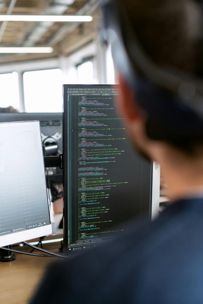 pexels photo 3861959 3861959 A male software engineer working on code in a modern office setting.