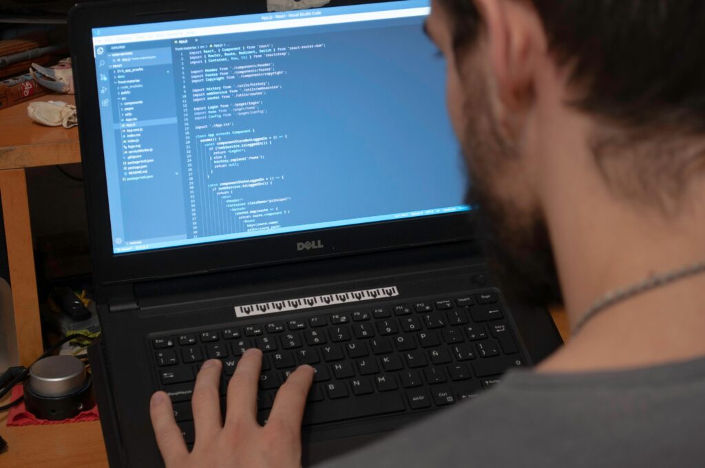 pexels photo 4078343 4078343 Man working on code on a laptop in an office, showcasing modern remote work setup.