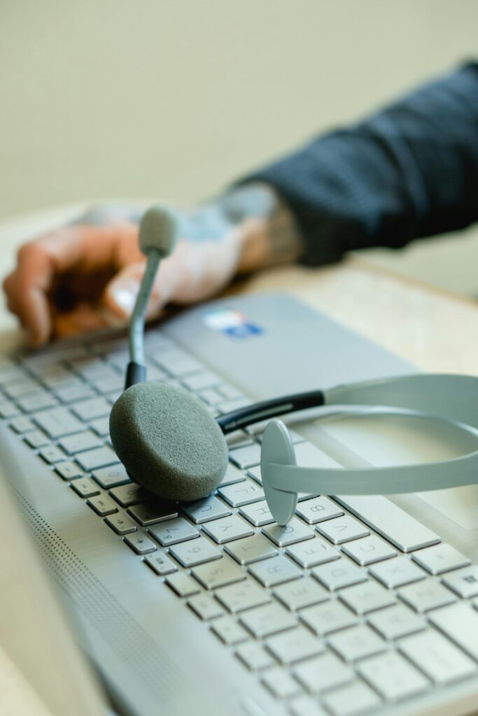 pexels photo 7504896 7504896 Close-up of a headset on a laptop keyboard, representing remote work and customer support.